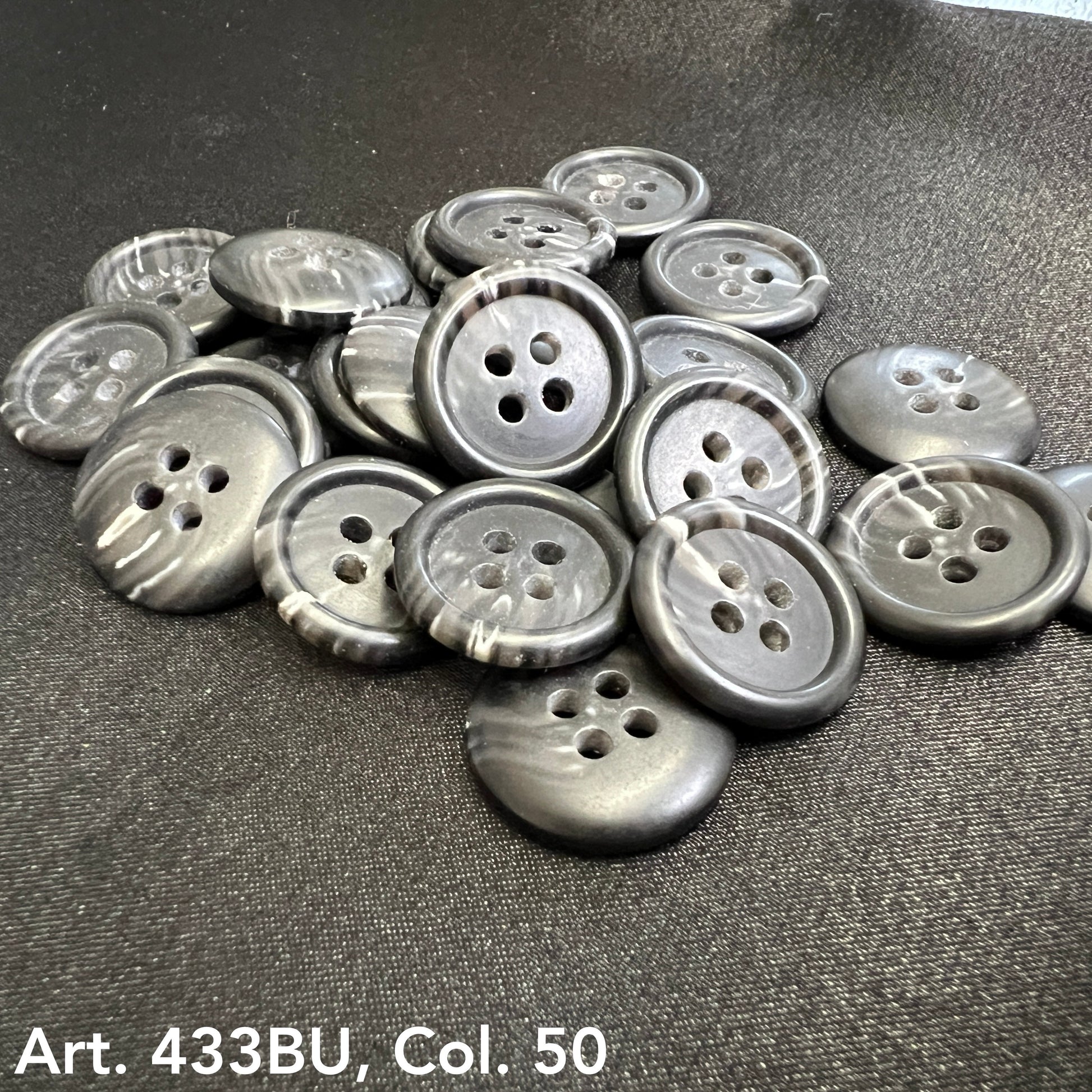 Collection of premium 4-hole sewing buttons in grey with a smooth finish, ideal for garment making