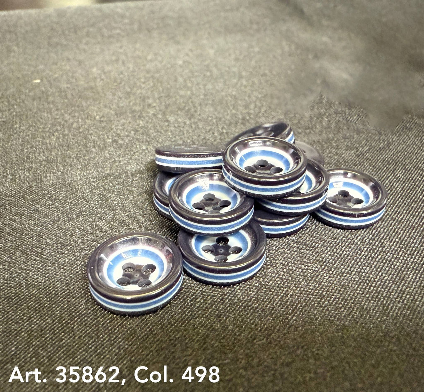 Stack of premium sewing buttons for coats with a glossy finish and four holes from Buttonology Inc