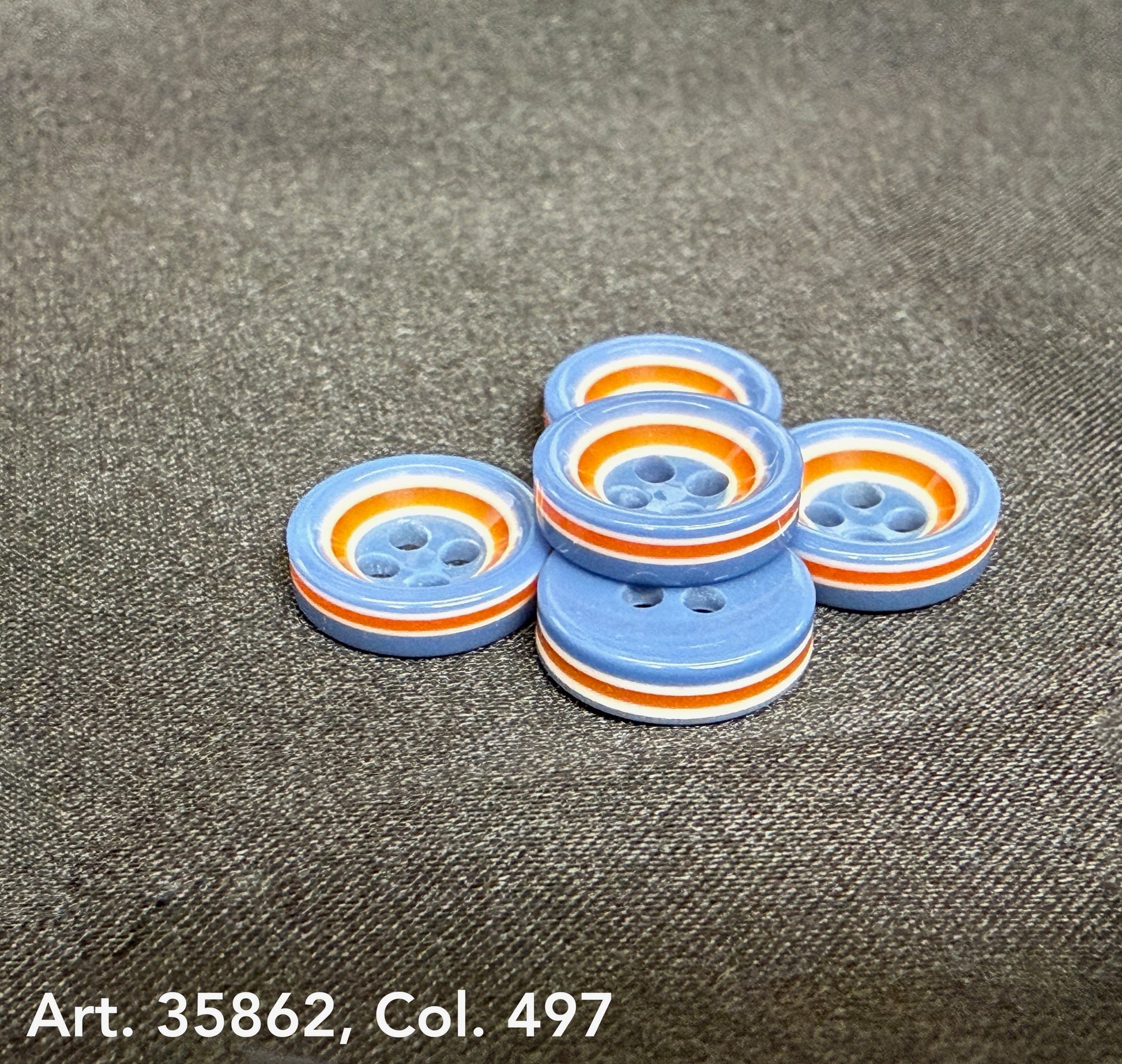 Premium sewing buttons for coats by Buttonology Inc with blue, orange, and white striped design