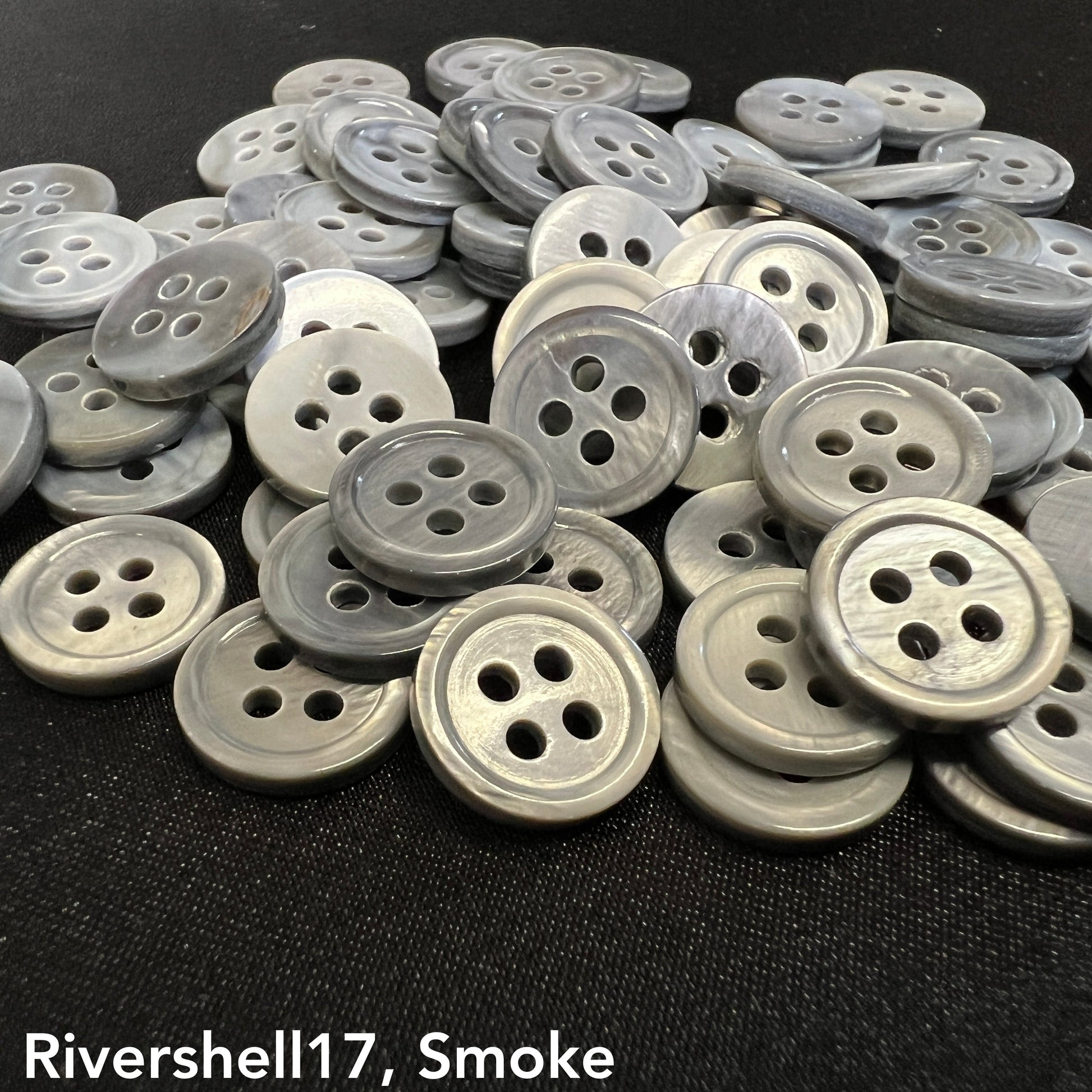 Rivershell buttons for clothing in smoke color, round four-hole design by Buttonology Inc