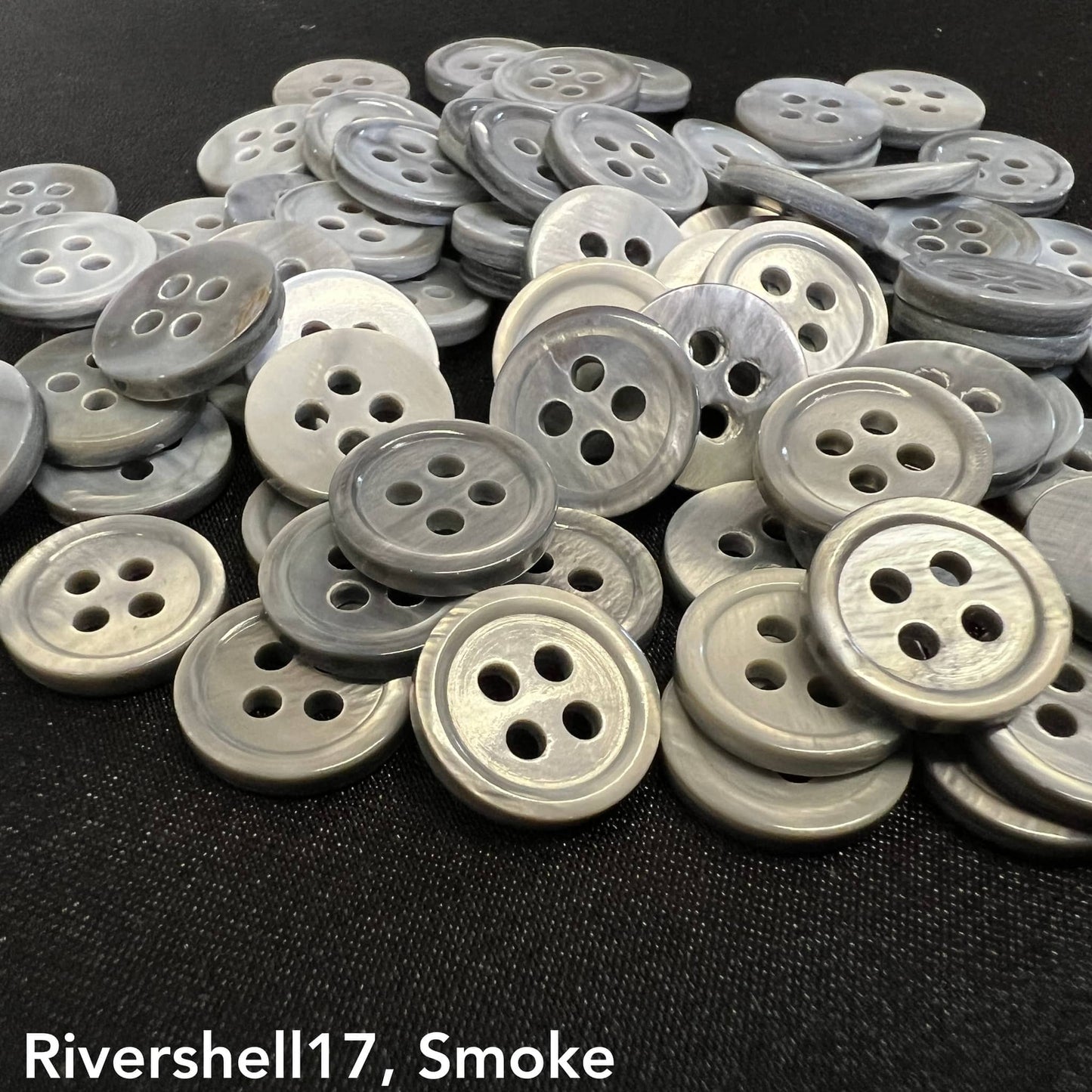 Rivershell buttons for clothing in smoke color, round four-hole design by Buttonology Inc