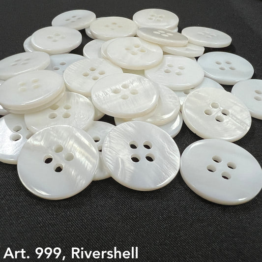 High-quality shell buttons in white with four holes from Buttonology Inc spread on black fabric