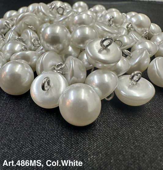 Buttonology Inc white pearl shank buttons piled on fabric showing glossy dome pearls with metal shanks for sewing