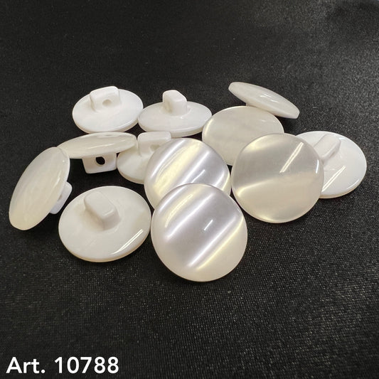White glossy shank buttons for garments by Buttonology Inc. arranged on black surface