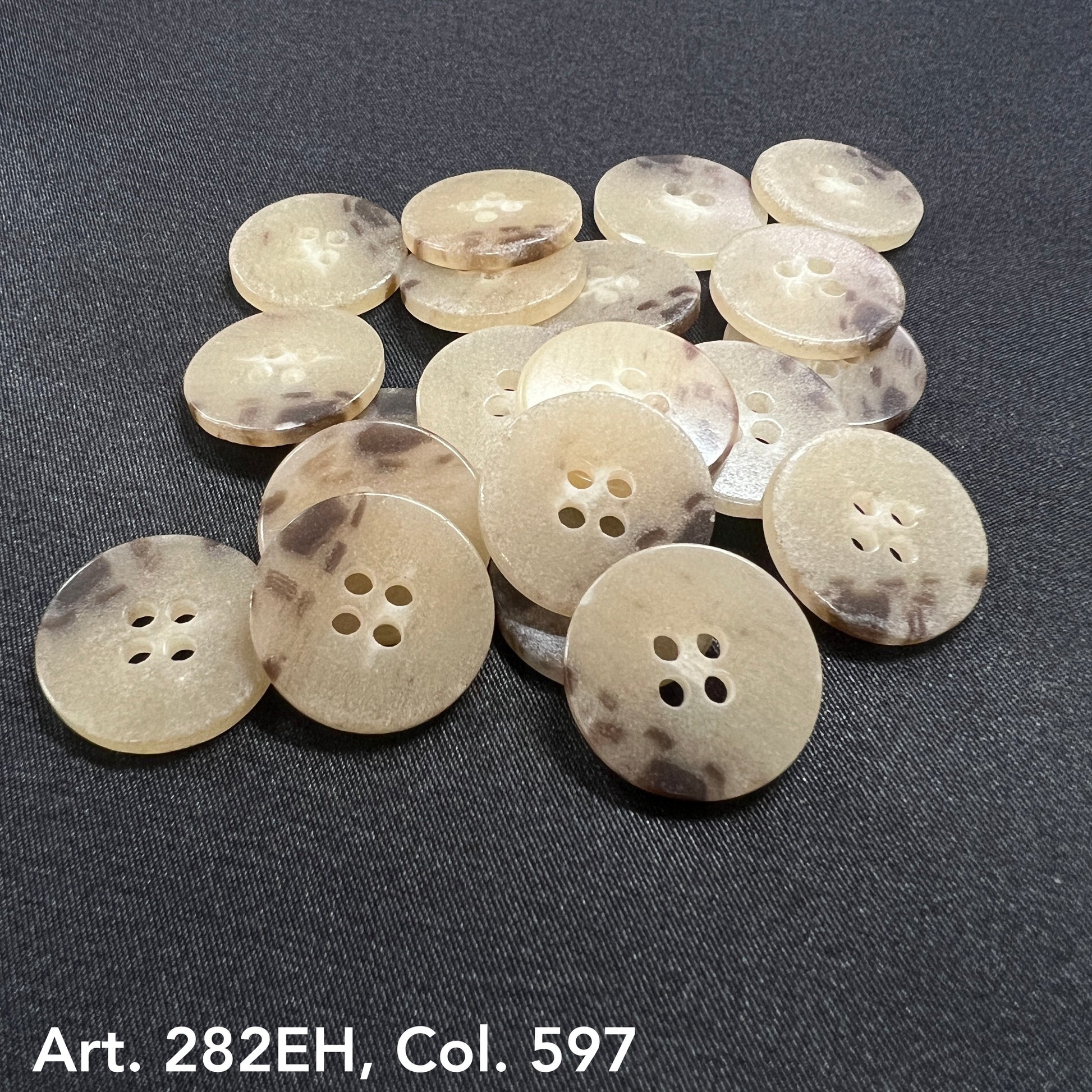 Buttonology Inc beige and brown shirt size buttons with four holes on black fabric background