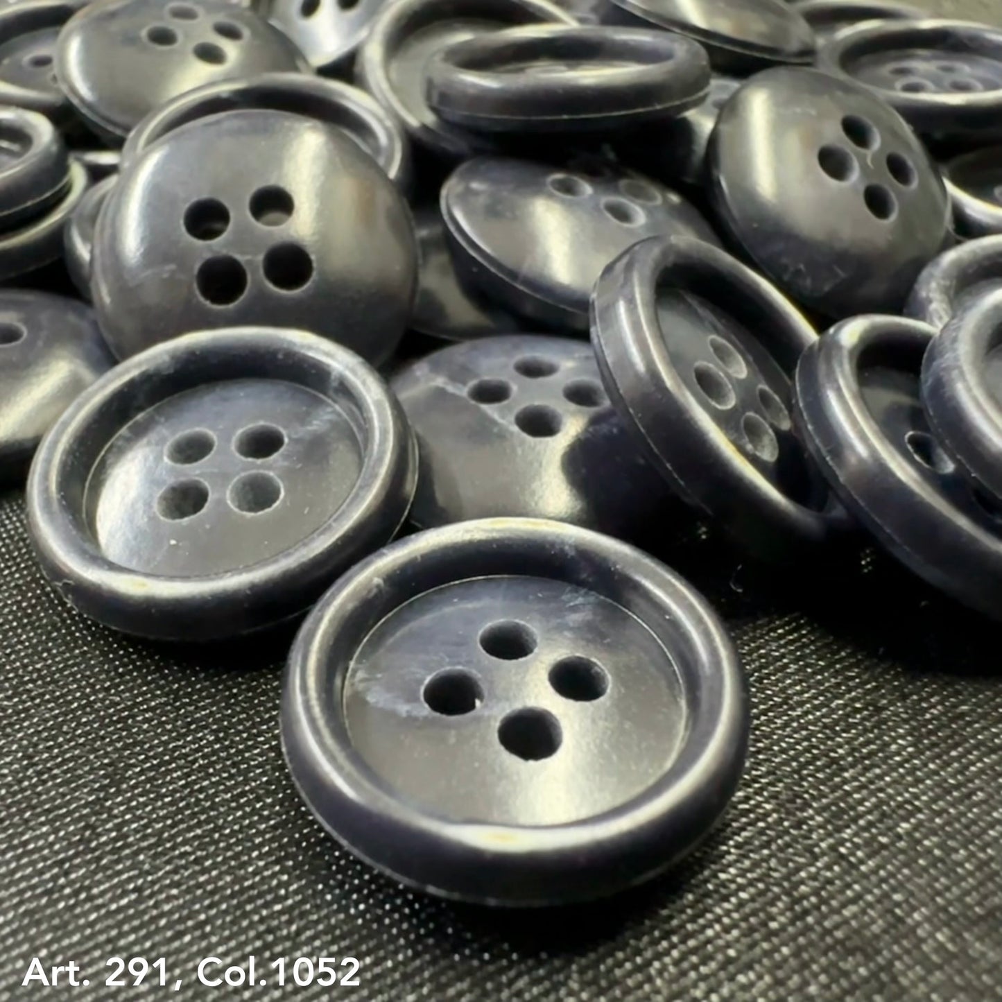 Collection of Buttonology Inc. shirting buttons 18L 20L in a dark color with four holes