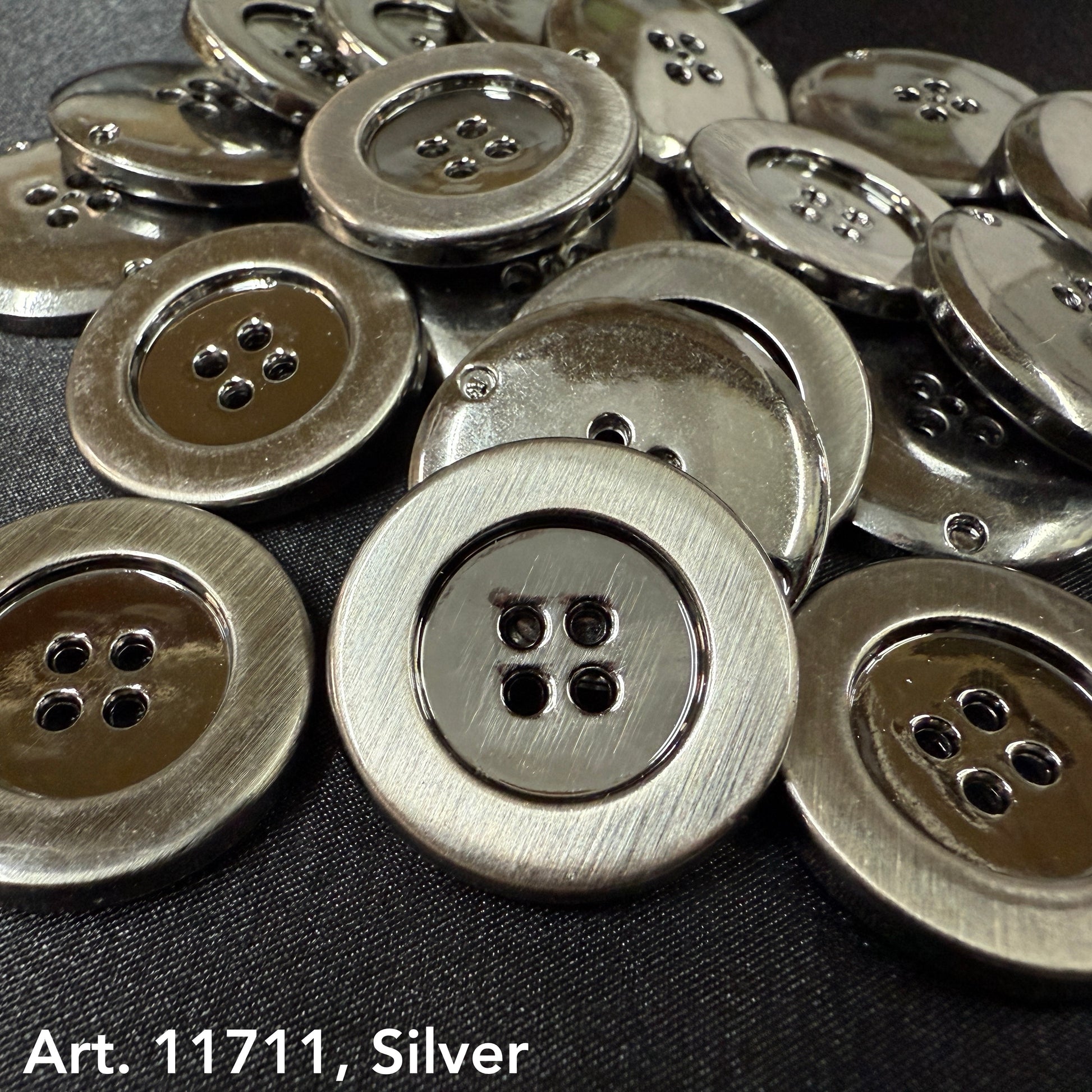 Silver metal sewing buttons with four holes and shiny finish from Buttonology Inc