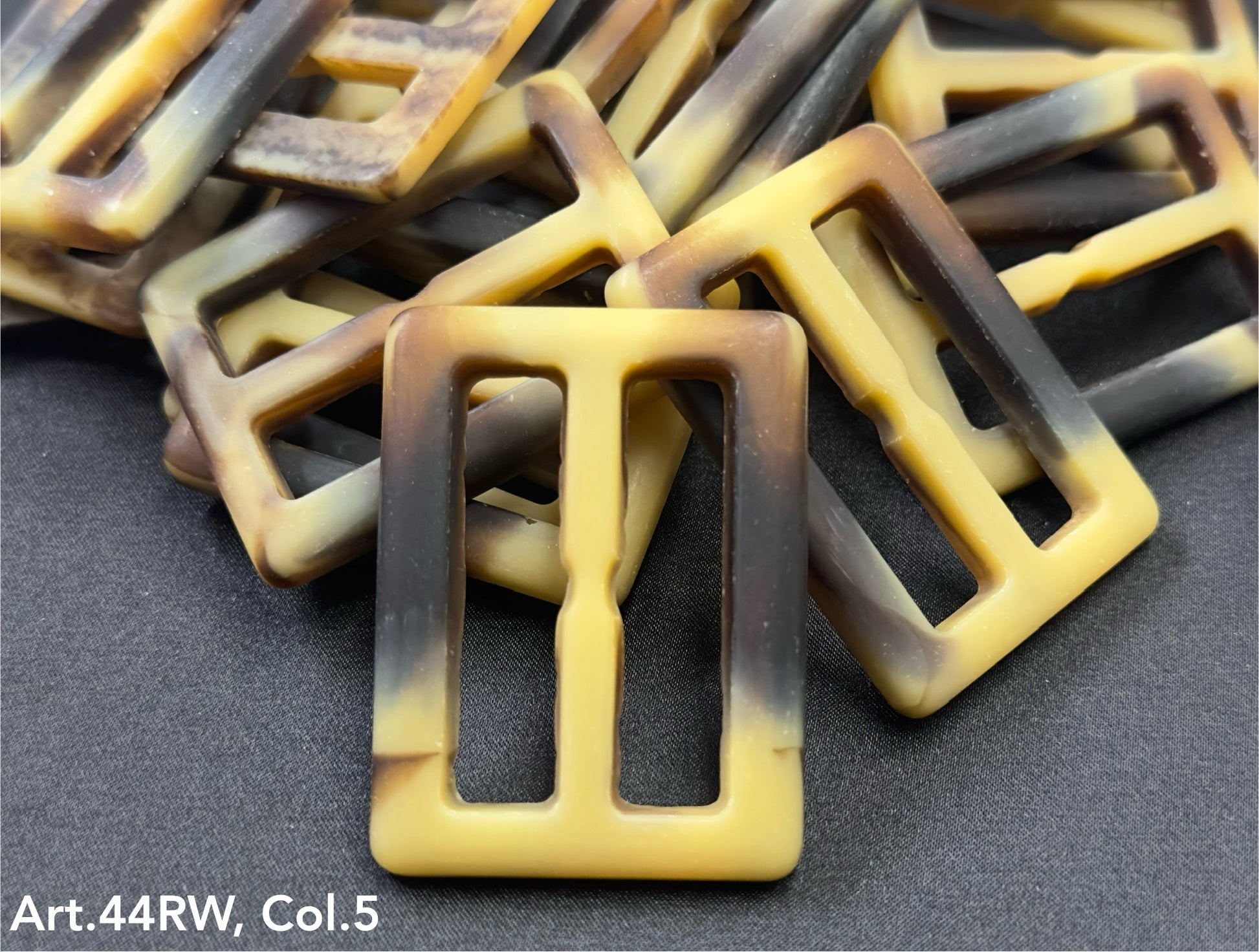 Strong polyester buckles by Buttonology Inc in a yellow and brown marbled design
