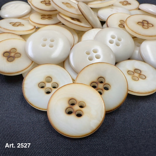Sustainable Burnt Corozo buttons for sale by Buttonology Inc with a natural ivory color and brown edges