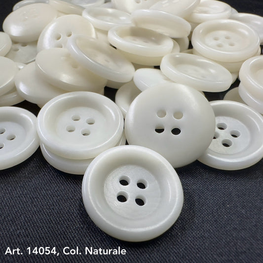 White sustainable fashion buttons with four holes from Buttonology Inc on black fabric background