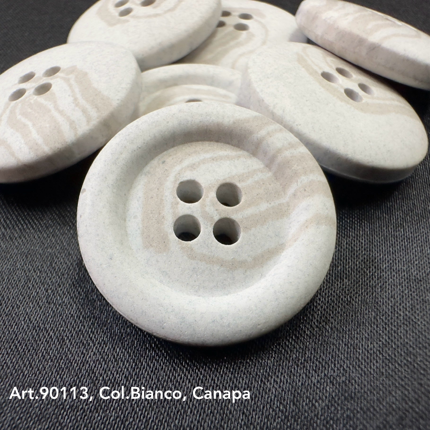 White sustainable Hemp buttons made by Buttonology Inc. with four holes and natural texture