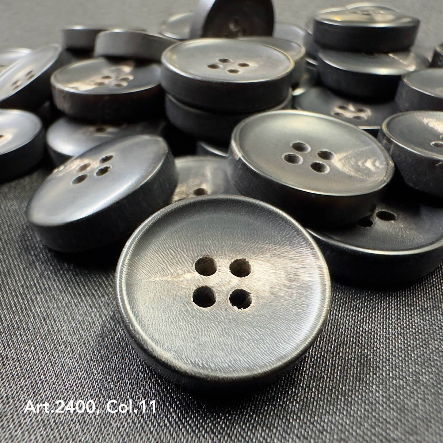 Sustainable horn buttons for suits by Buttonology Inc with natural texture and four holes