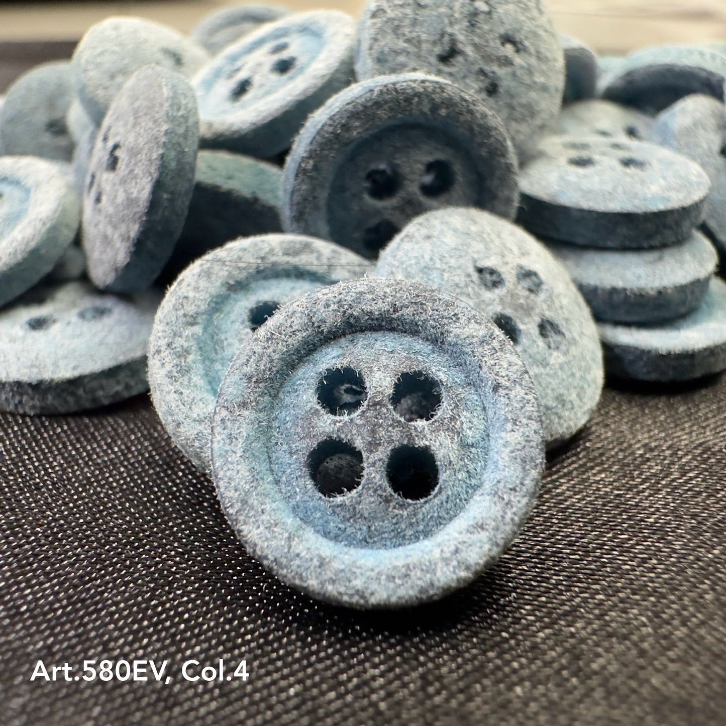 Eco-friendly velvet buttons by Buttonology Inc in soft blue with four-hole design