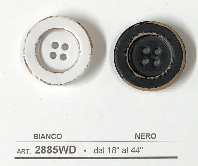 Two buttons from Buttonology Inc, featuring a distressed white wooden button for sewing and a black button