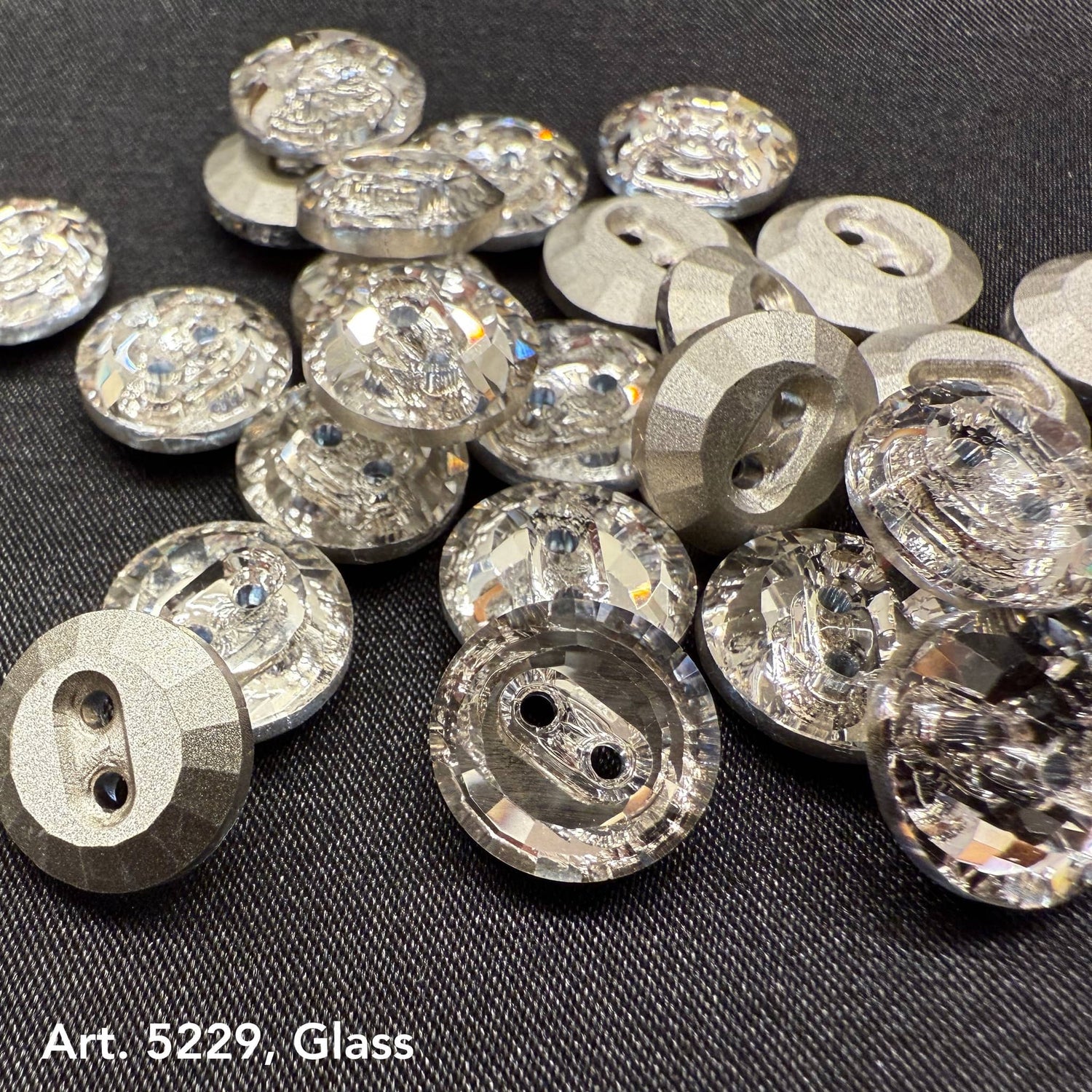 Buy glass buttons for garments featuring high-quality clear faceted round designs on dark fabric