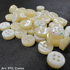Assorted creamy 4 hole garment buttons from Buttonology Inc for sewing and crafting projects