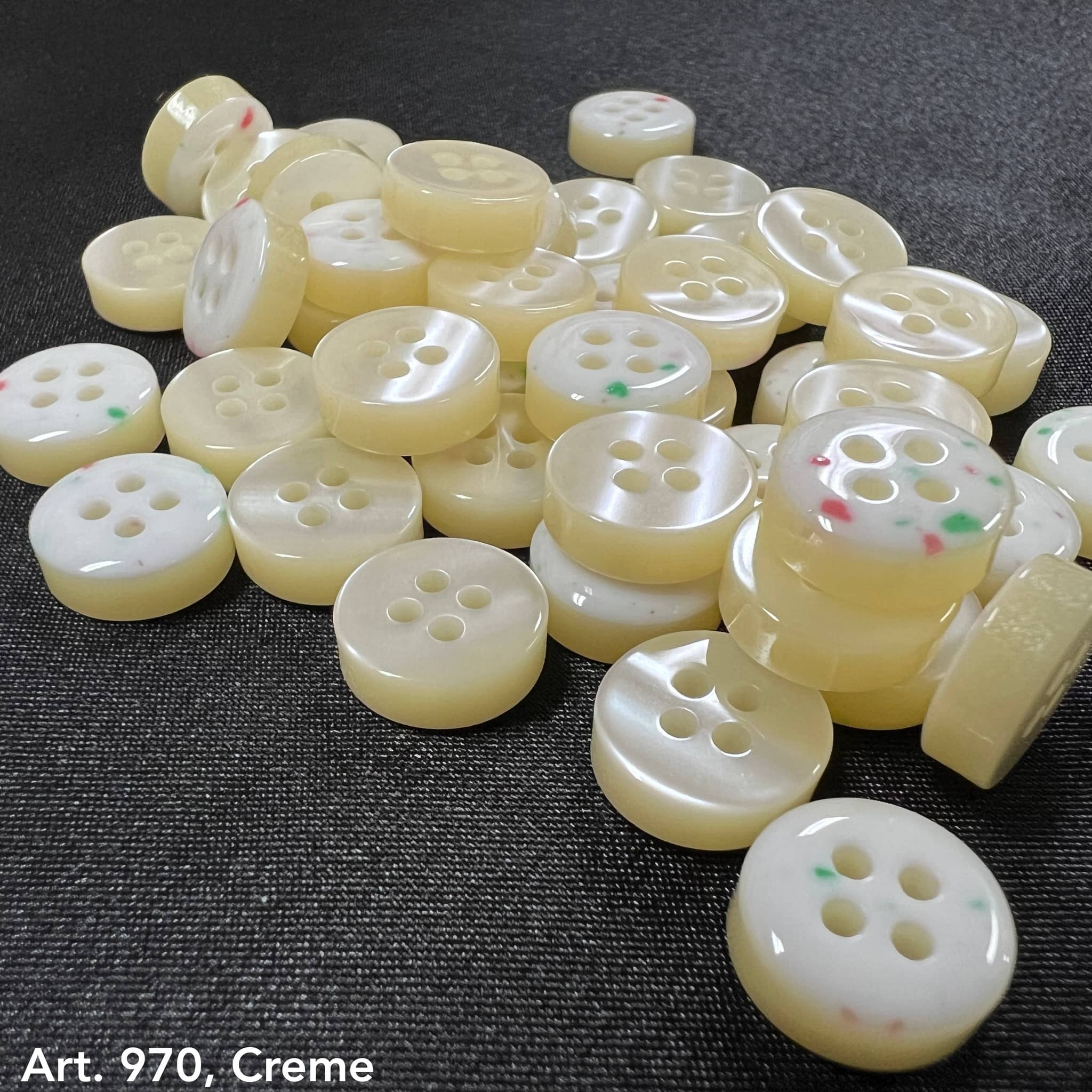 Assorted creamy 4 hole garment buttons from Buttonology Inc for sewing and crafting projects