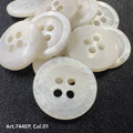 White 4-hole plastic buttons by Buttonology Inc. arranged on a dark fabric background