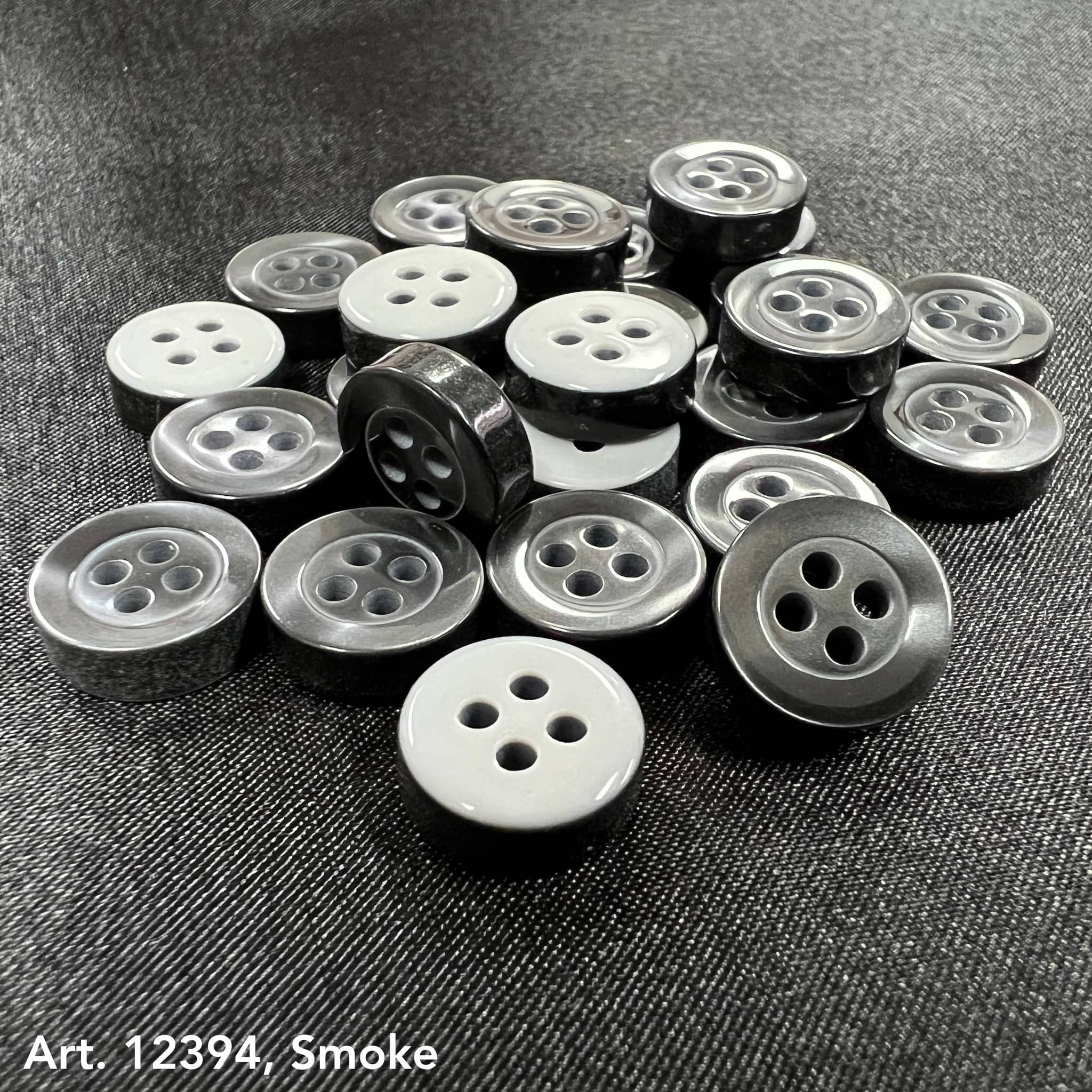 Assorted 4-hole sewing buttons for clothing in gray shades with shiny finish