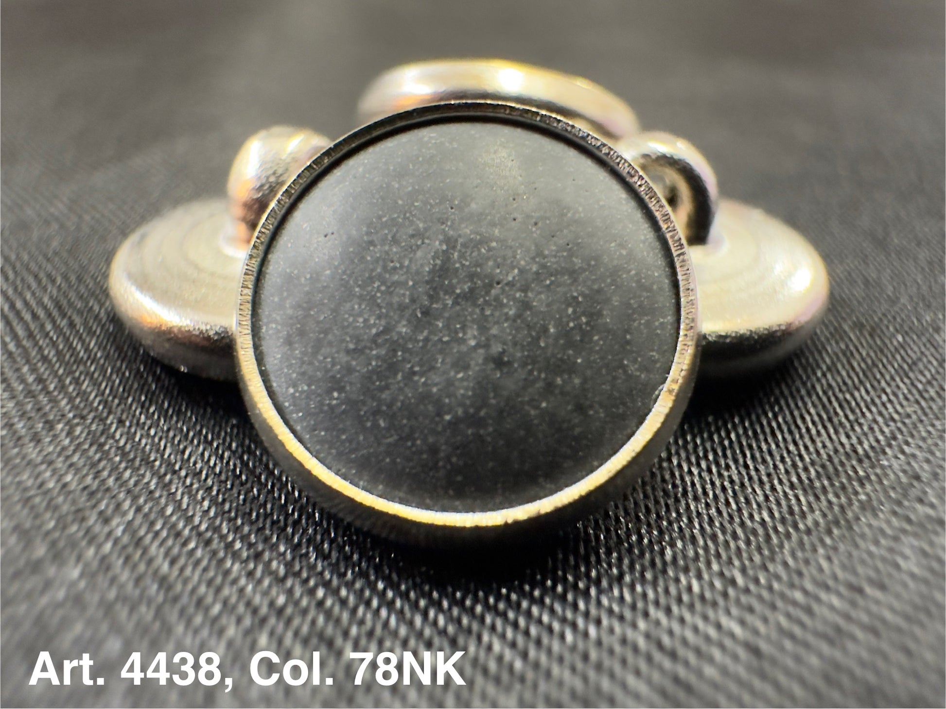 Buttonology Inc polyester garment shank round metal shank button with black center on textured fabric