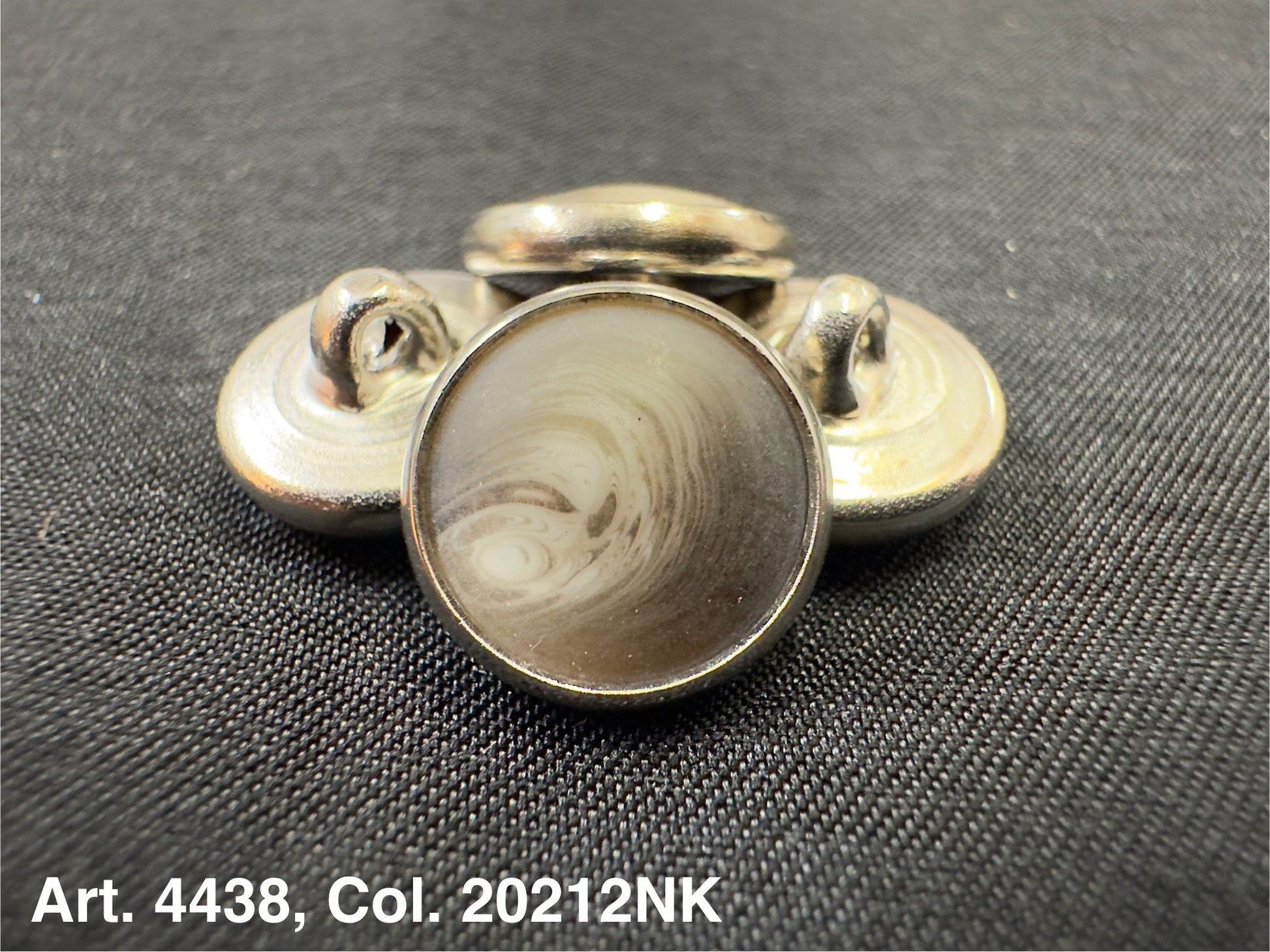 Buttonology Inc round metal button shank with marbled center on black fabric polyester garment shank