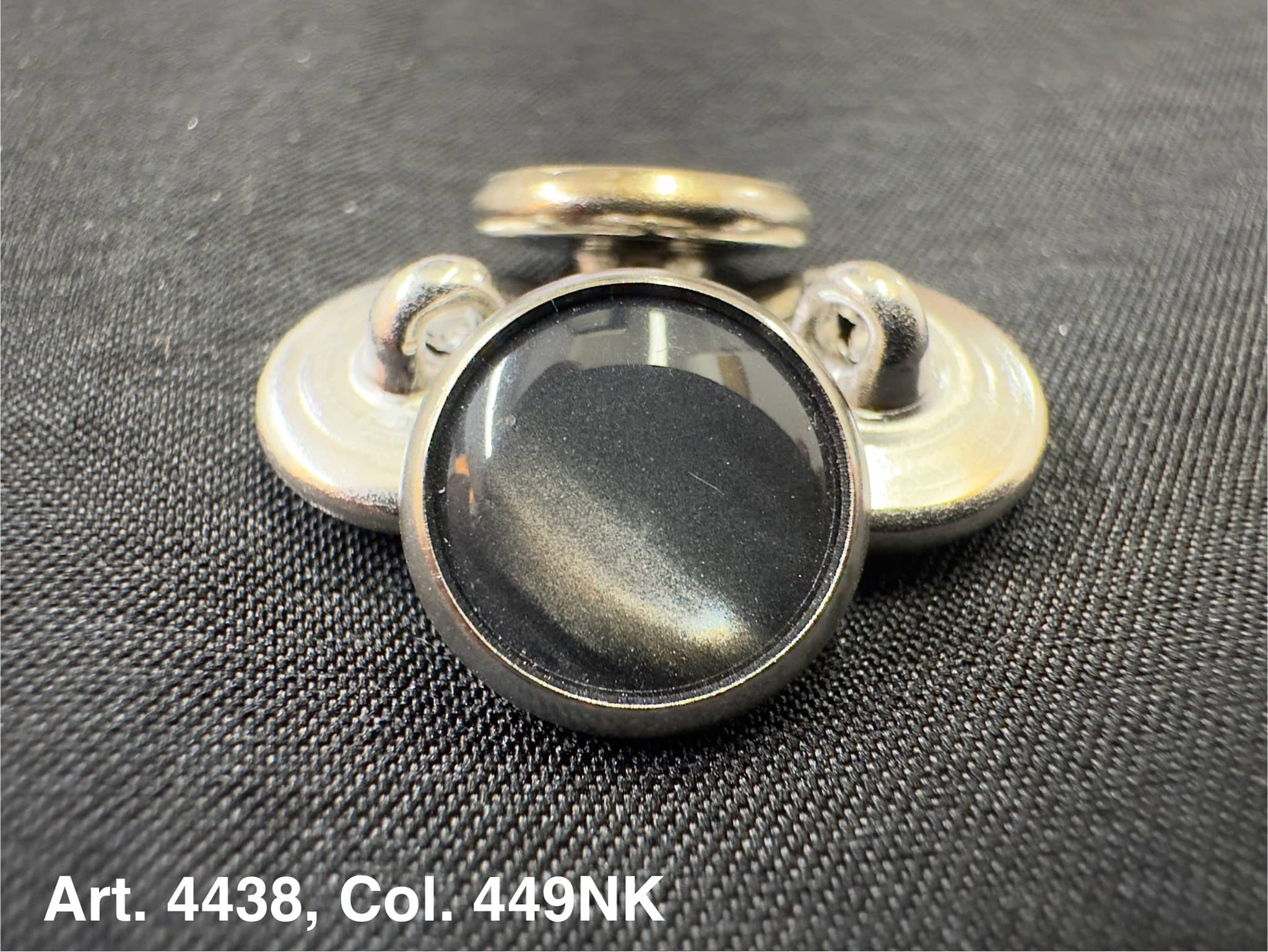 Buttonology Inc polyester garment shank black domed metal shank buttons arranged on textured black fabric