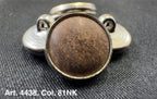 Buttonology Inc polyester garment shank with brown faux leather center and metal backing on black fabric