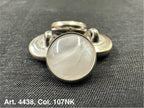 Buttonology Inc polyester garment shank with pearlescent white cabochon and silver metal rim on black fabric