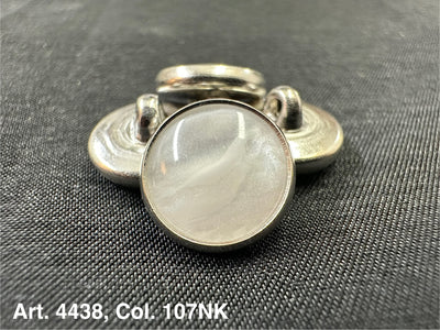 Buttonology Inc polyester garment shank with pearlescent white cabochon and silver metal rim on black fabric
