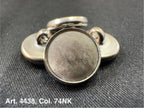 Buttonology Inc polyester garment shank metal button back piece on black woven fabric close up for clothing repairs