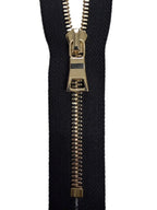 Black zipper with gold metal teeth on a white background
