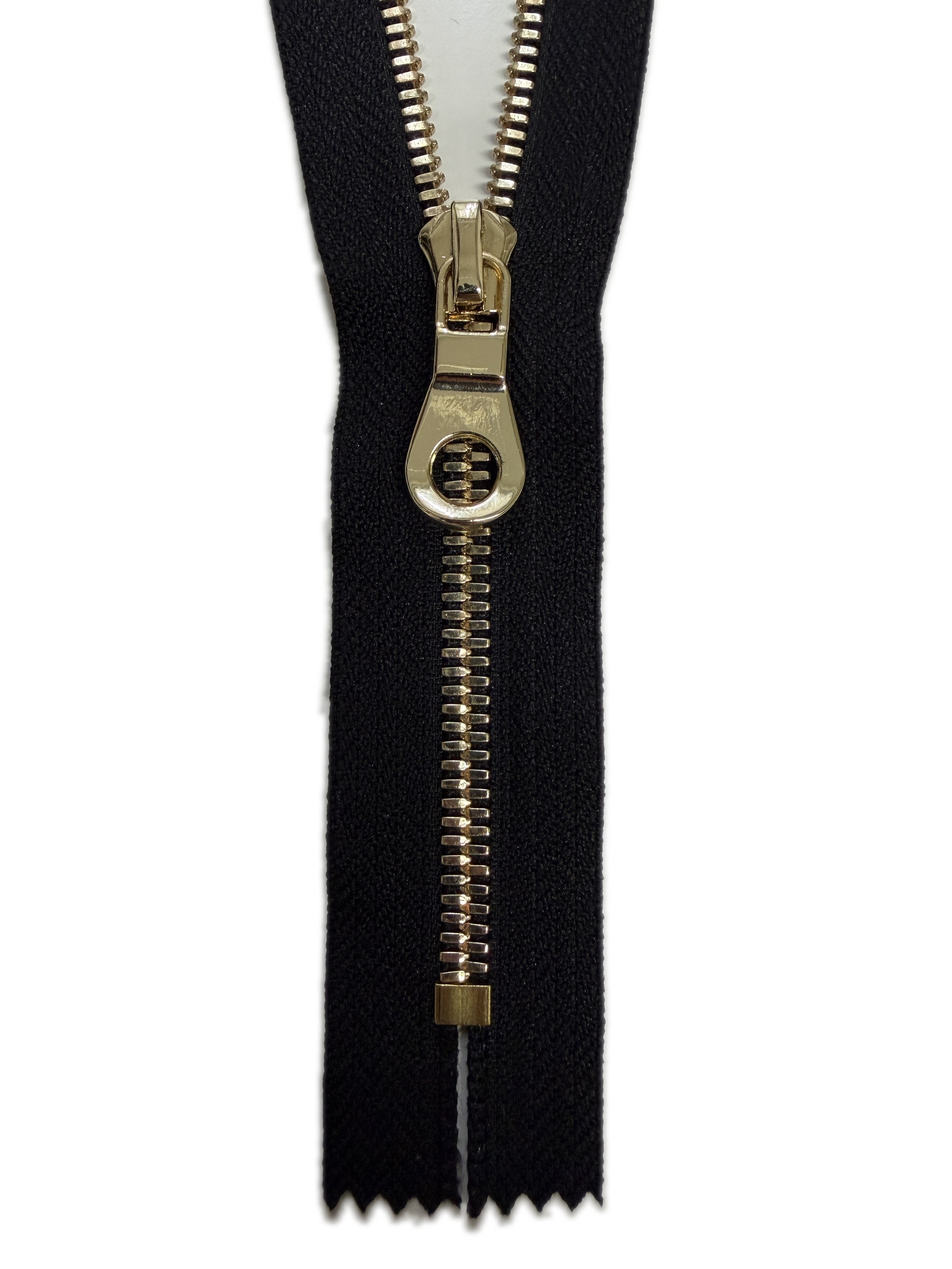 Black zipper with gold pull on a white background