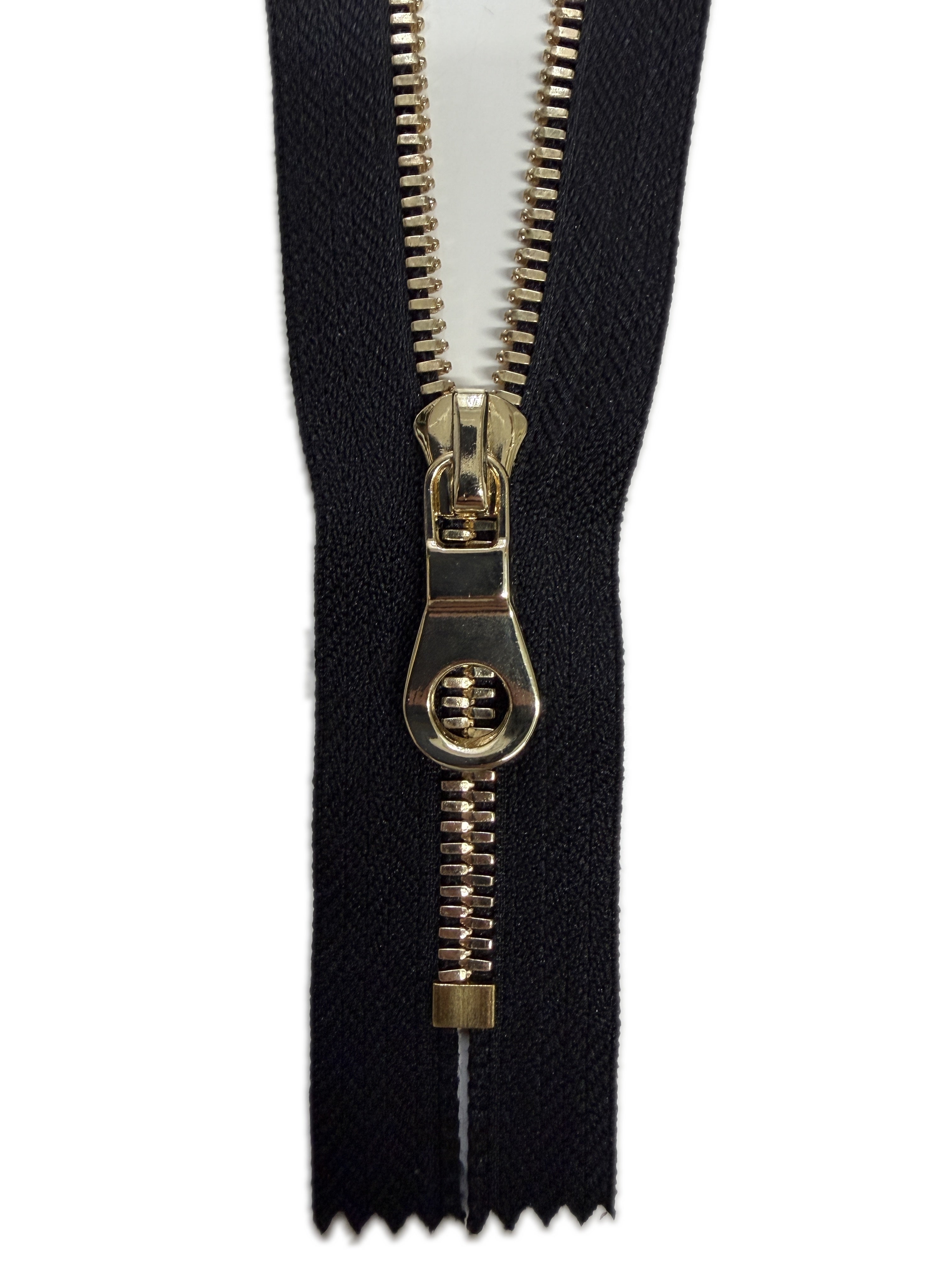 Black zipper with gold pull on a white background