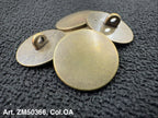 Four round brass tags on a textured black surface with 'Art. ZM50366, Col. OA' text.