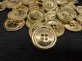 Gold buttons on a black textured surface