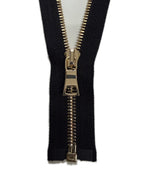 Black fabric with a gold zipper on a white background