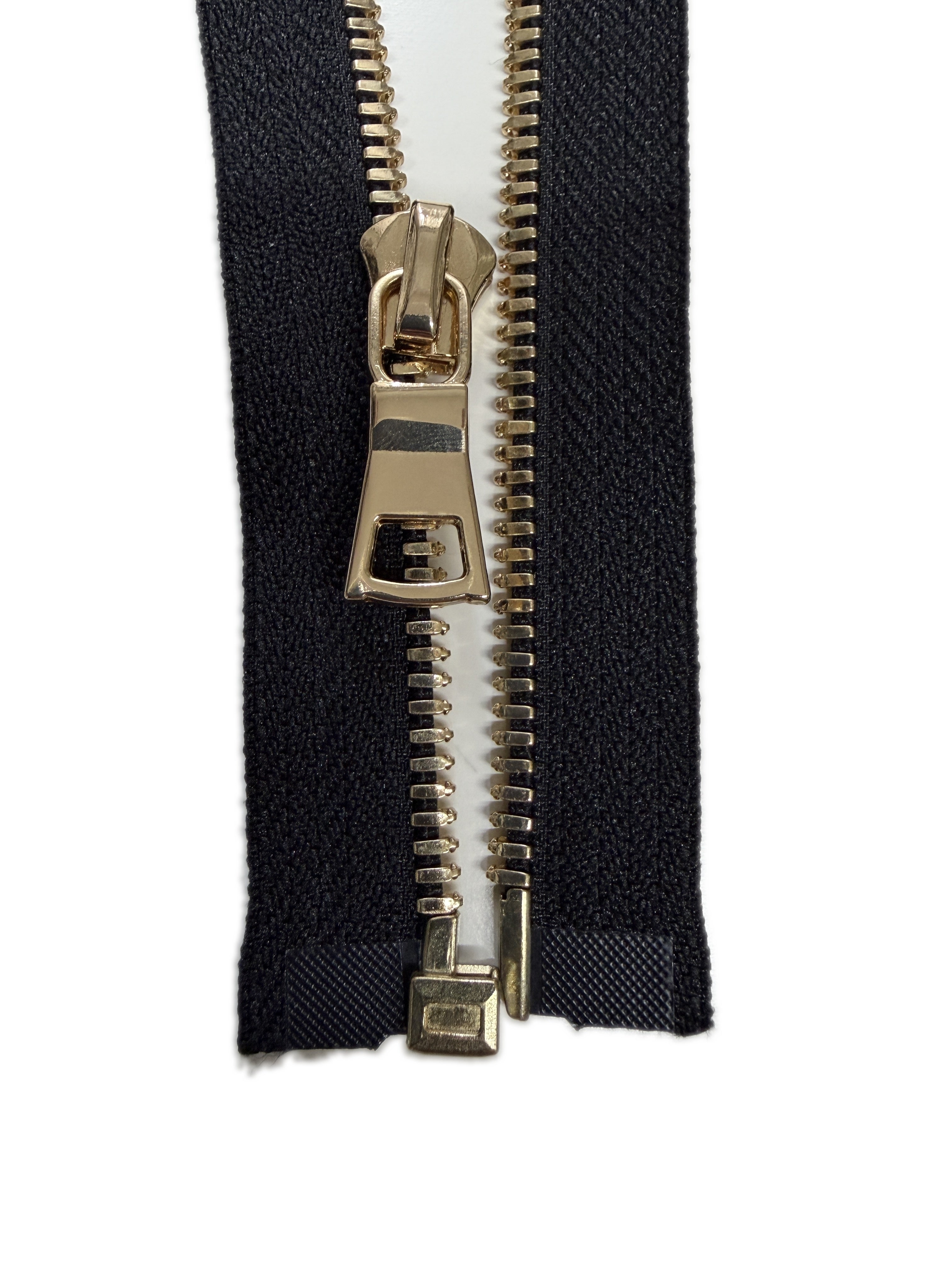 Gold zipper on black fabric background