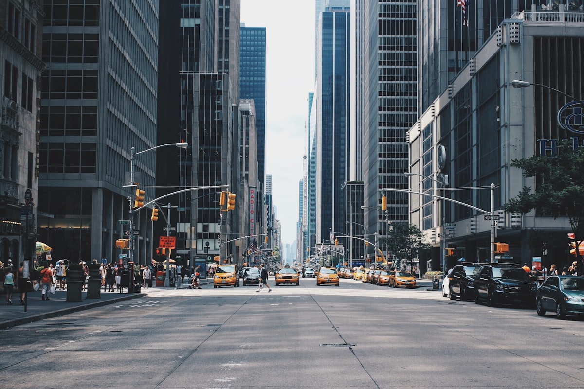 City street with tall buildings and traffic lights on a clear day