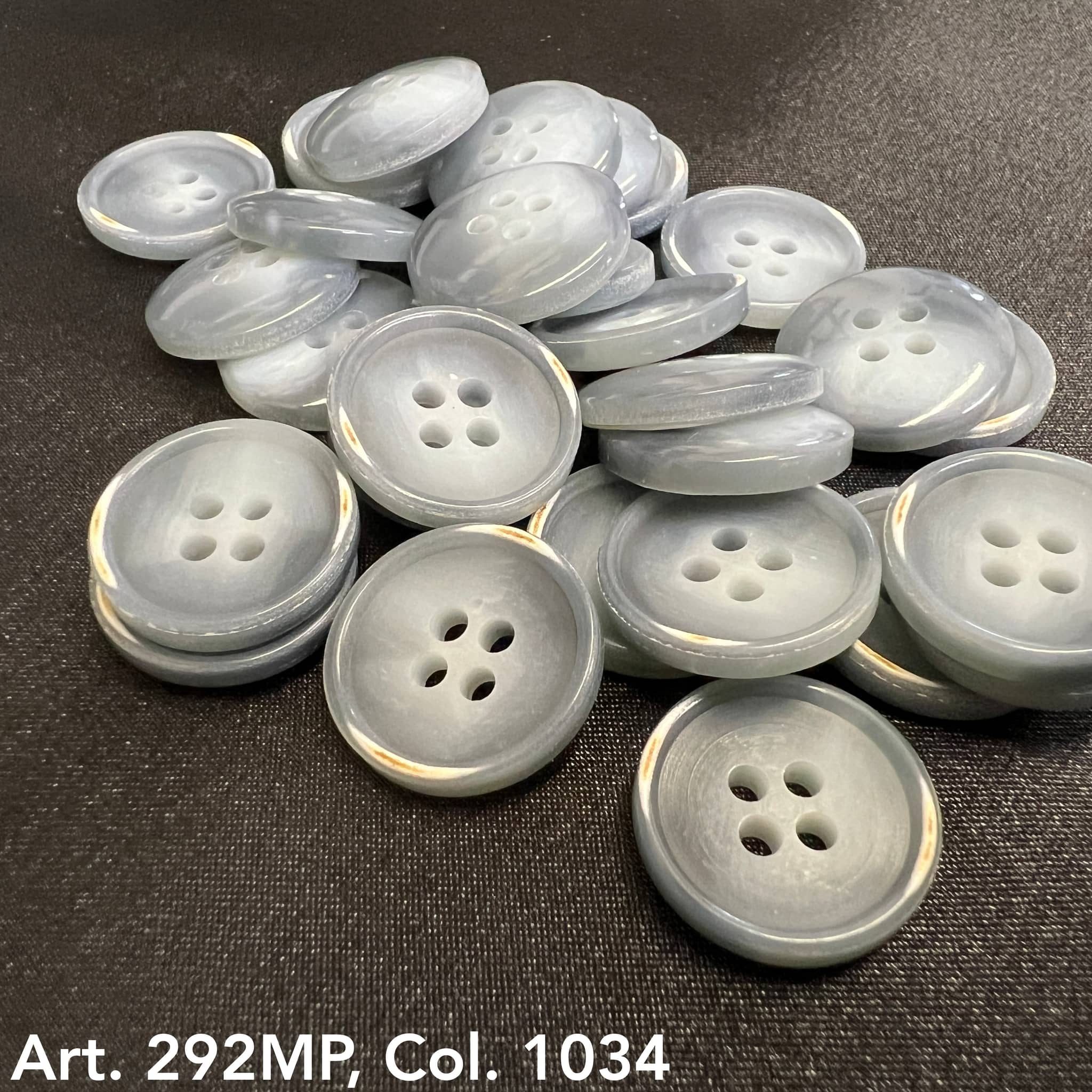 Buttonology Inc light gray pearlized round four hole buttons on black fabric for shirt buttons for sewing