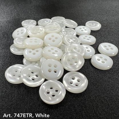 Buttonology Inc smoke four-hole buttons in white arranged on black fabric surface