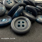 Close-up of dark recycled paper buttons by Buttonology Inc with four holes on black fabric