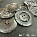 Dark glossy natural horn sewing button set showing four hole large vintage style buttons on black fabric