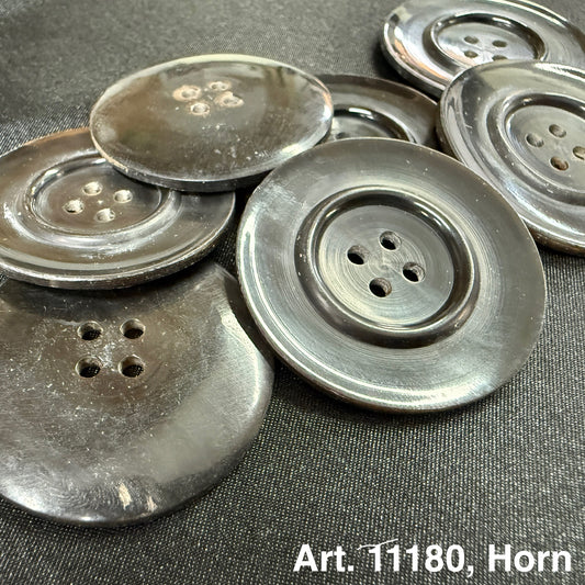 Dark glossy natural horn sewing button set showing four hole large vintage style buttons on black fabric