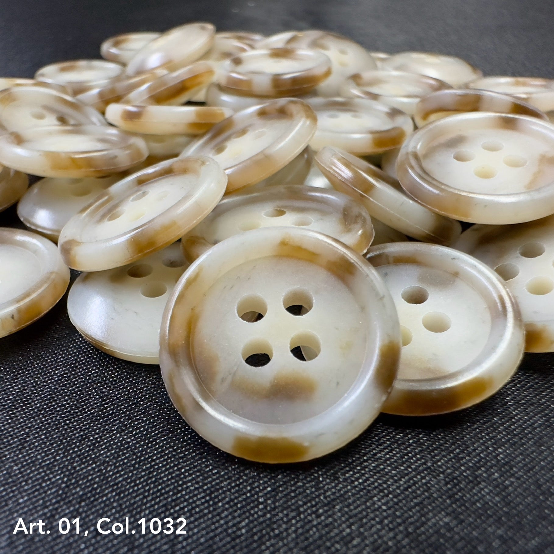 Buttonology Inc beige marbled four hole buttons on dark fabric premium shirt buttons for sewing