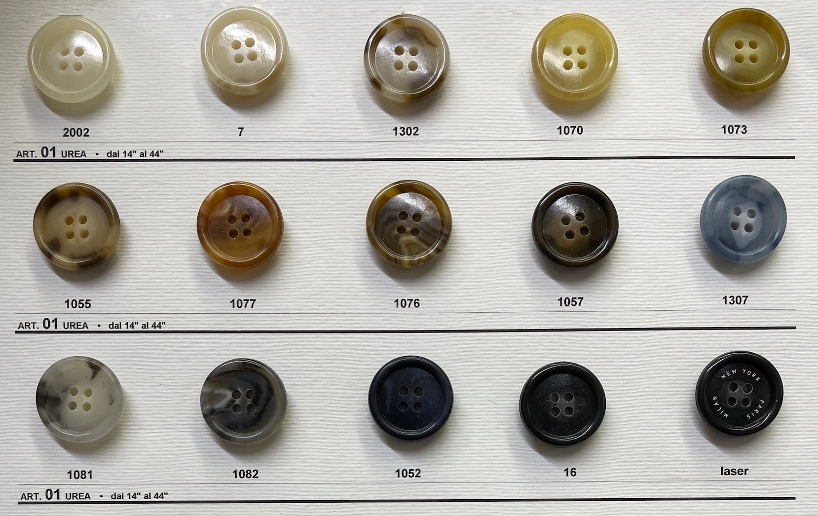 Buttonology Inc sample card showing rows of assorted beige brown gray and black buttons premium shirt buttons for sewing