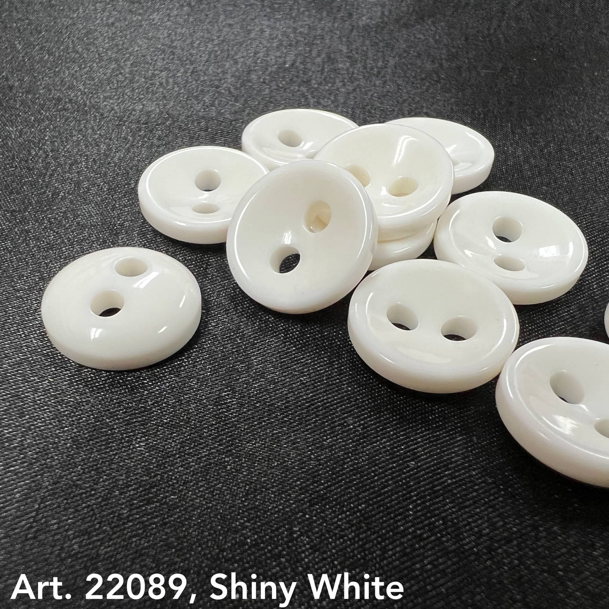 Buttonology Inc shiny white round buttons on black fabric Art 22089 glossy discs buy shiny black buttons online