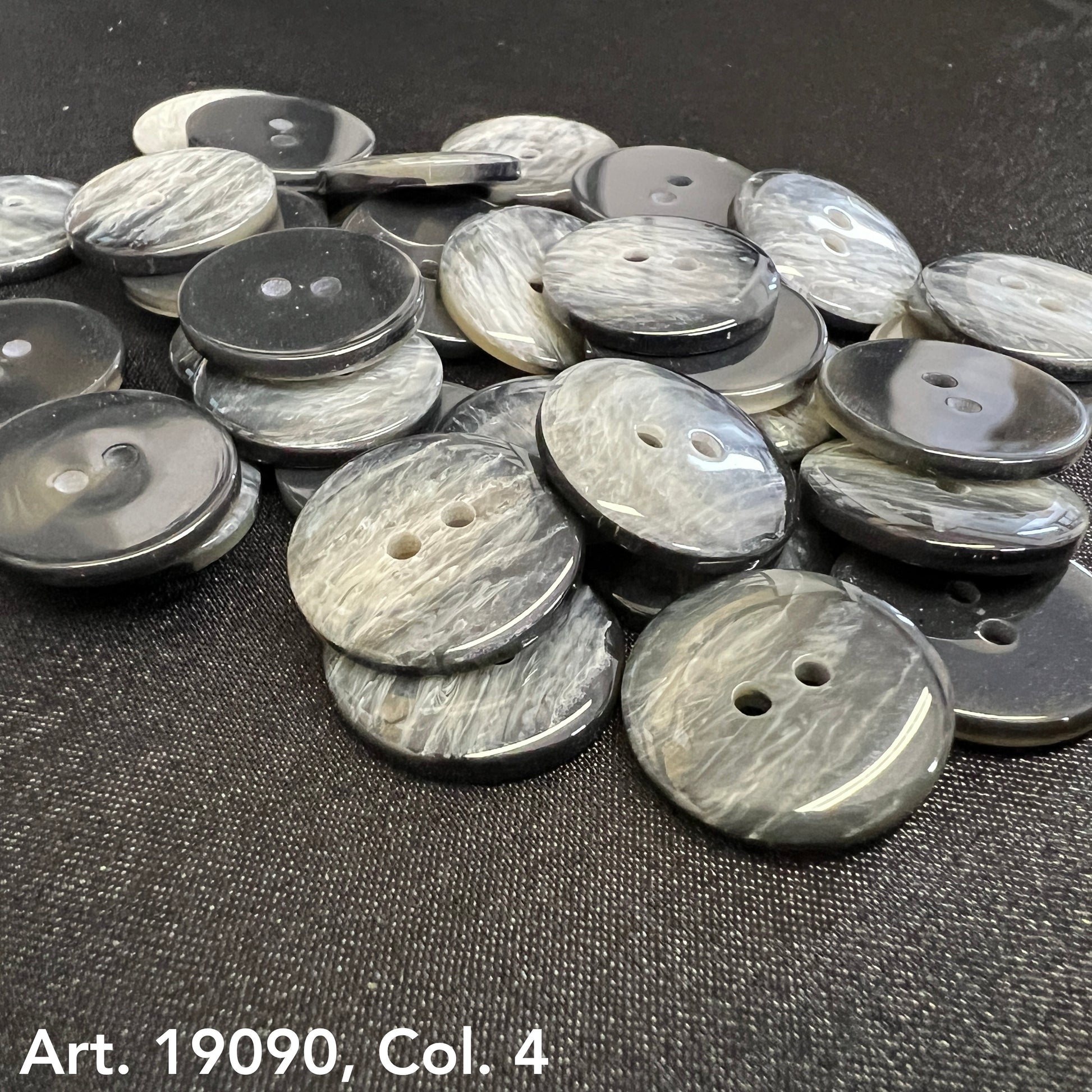 Buy Two Hole Buttons Online gray marbled buttons by Buttonology Inc scattered on black surface