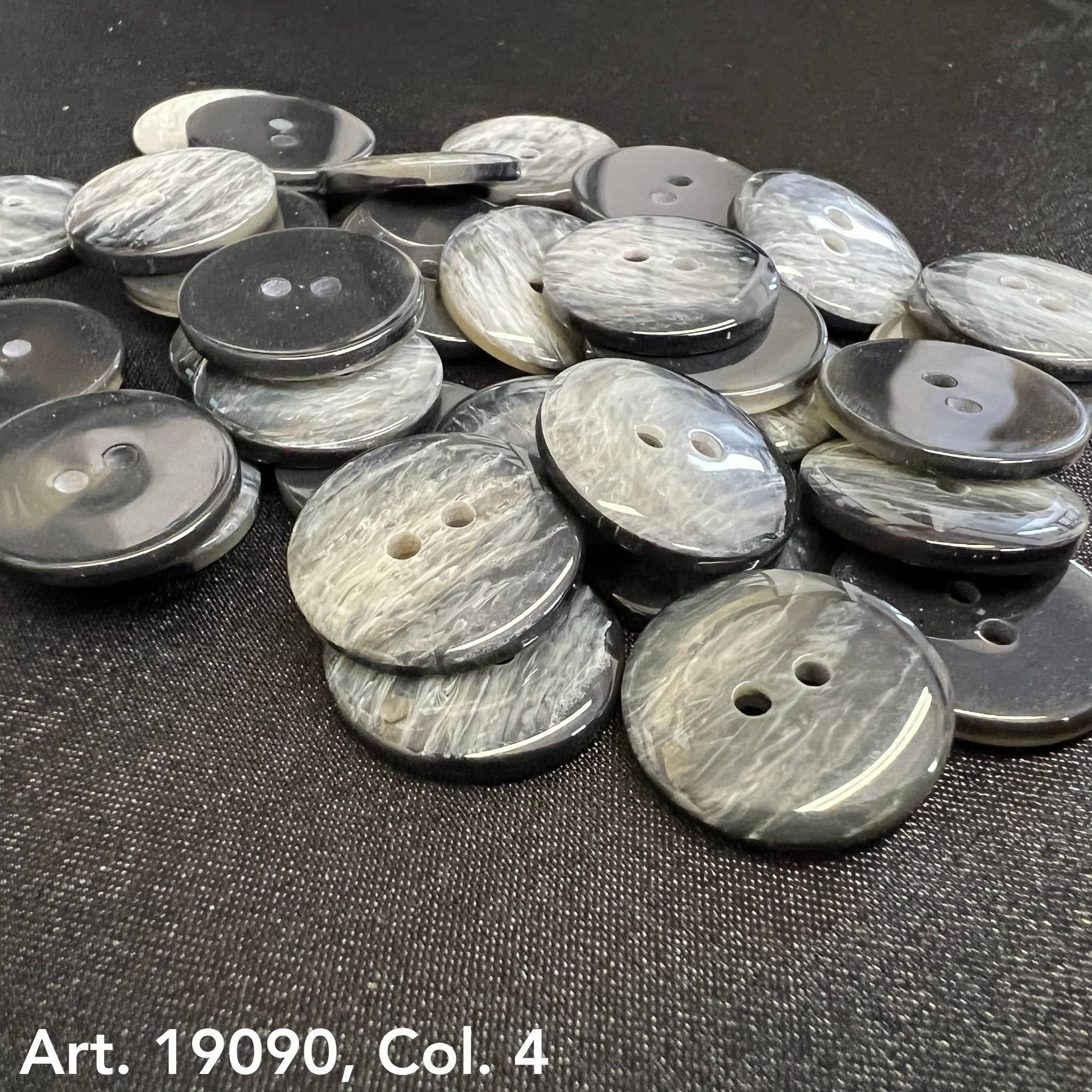 Buy Two Hole Buttons Online gray marbled buttons by Buttonology Inc scattered on black surface