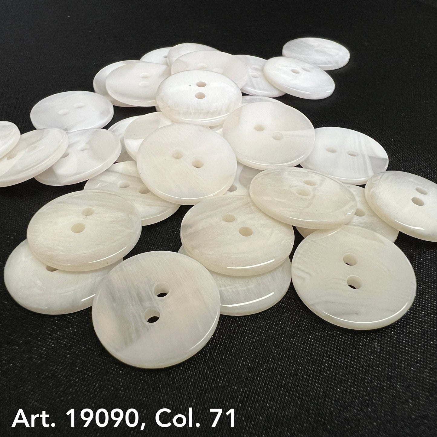 White two hole buttons from Buttonology Inc on black surface buy two hole buttons online