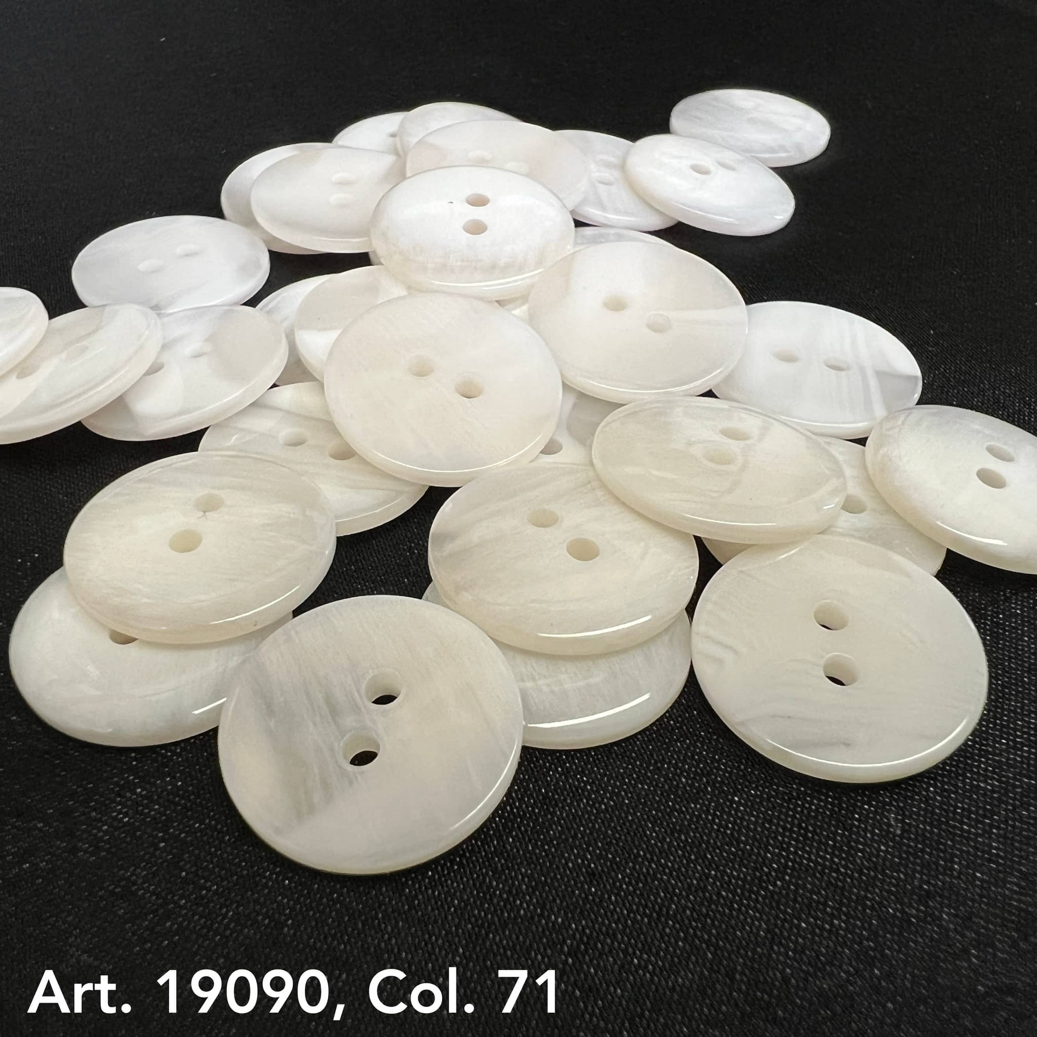 White two hole buttons from Buttonology Inc on black surface buy two hole buttons online